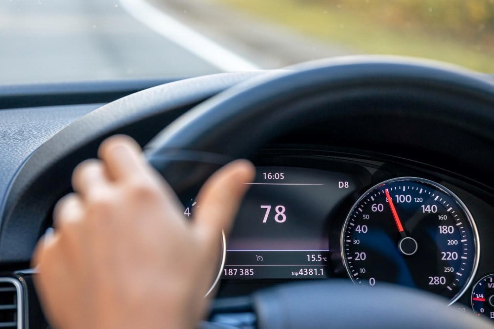 Steering wheel in a car close up high speed driving on the road