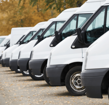 Line up of white commercial vans