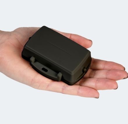 Black tracking device in a hand
