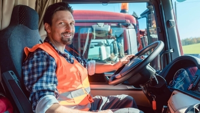 Photo of a man driving a large truck