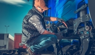 Man repairing a large tire